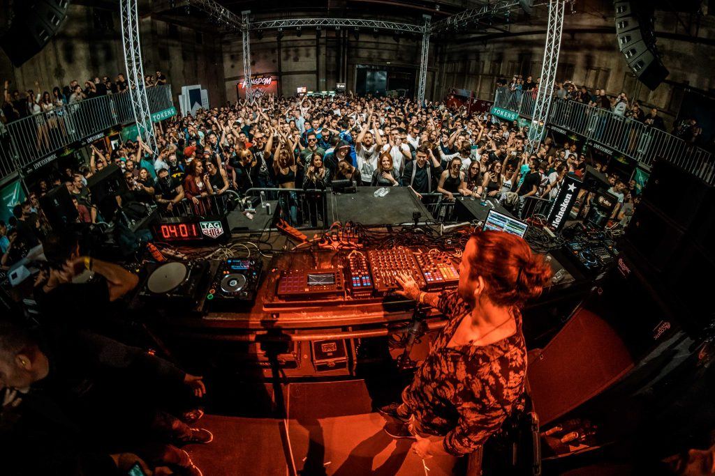 Luciano playing to a crowd in a club, using Traktor setup