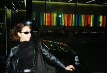 Fun photo of Malika leaning against a car