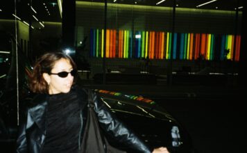 Fun photo of Malika leaning against a car