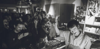 Tomoki Tamura: Timeless, From Osaka to Berlin Tomoki Tamura DJing in a crowded record shop, black and white photo