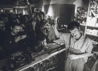 Tomoki Tamura: Timeless, From Osaka to Berlin Tomoki Tamura DJing in a crowded record shop, black and white photo